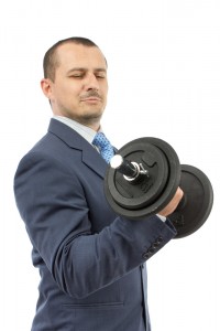 Man in suit lifting weights.