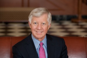 Mr. Bill George, a member of the Mayo Clinic Board of Trustees in jacket, blue shirt and red tie