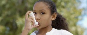 girl using asthma inhaler