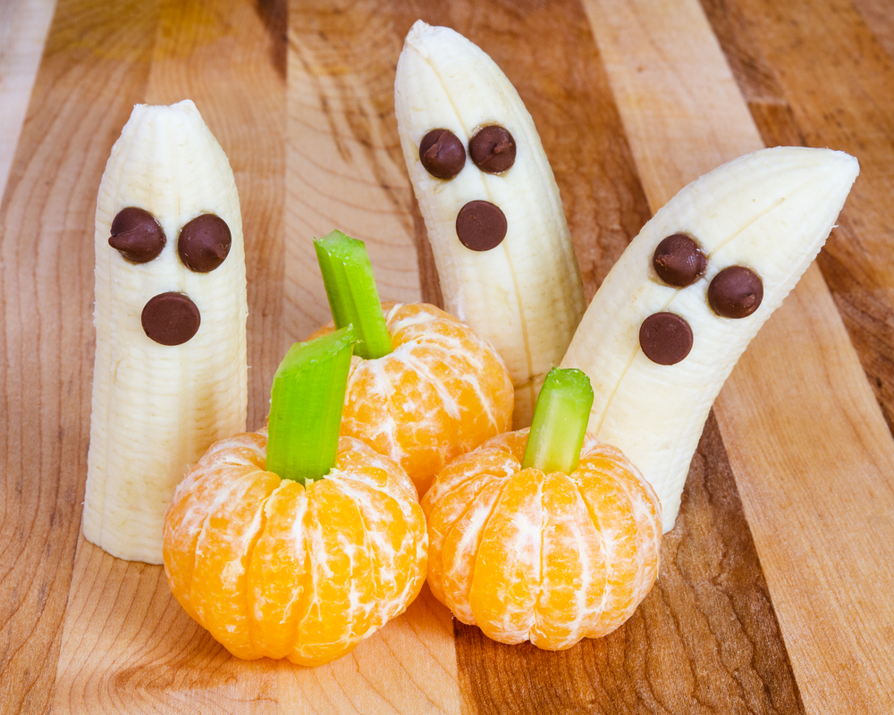 Halloween treats - bananas with chocolate chips, clementines with celery sticks