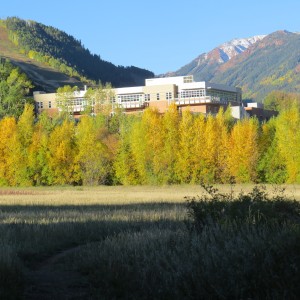 Wide shot of the Aspen Valley Hospital with fall leaves on trees and blue sky in the background