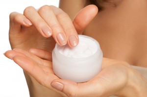 Woman's hands holding jar of skin care moisturizer cream