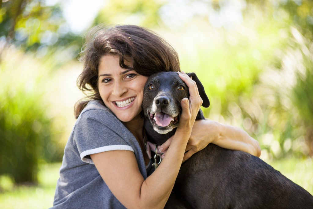 Pet therapy with woman hugging black dog