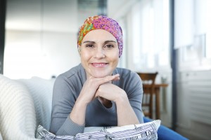 Woman cancer survivor with scarf on her head after chemo