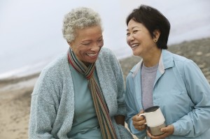 friendship - two women laughing together and sharing friendship - diversity