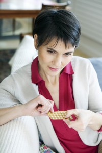 woman holding hormone replacement medication