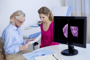 woman discussing breast screening with medical staff