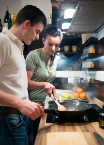 young couple in kitchen cooking healthy meal