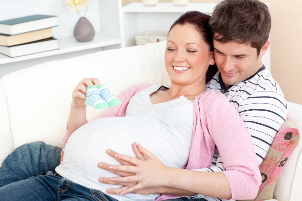 pregnant couple smiling and happy