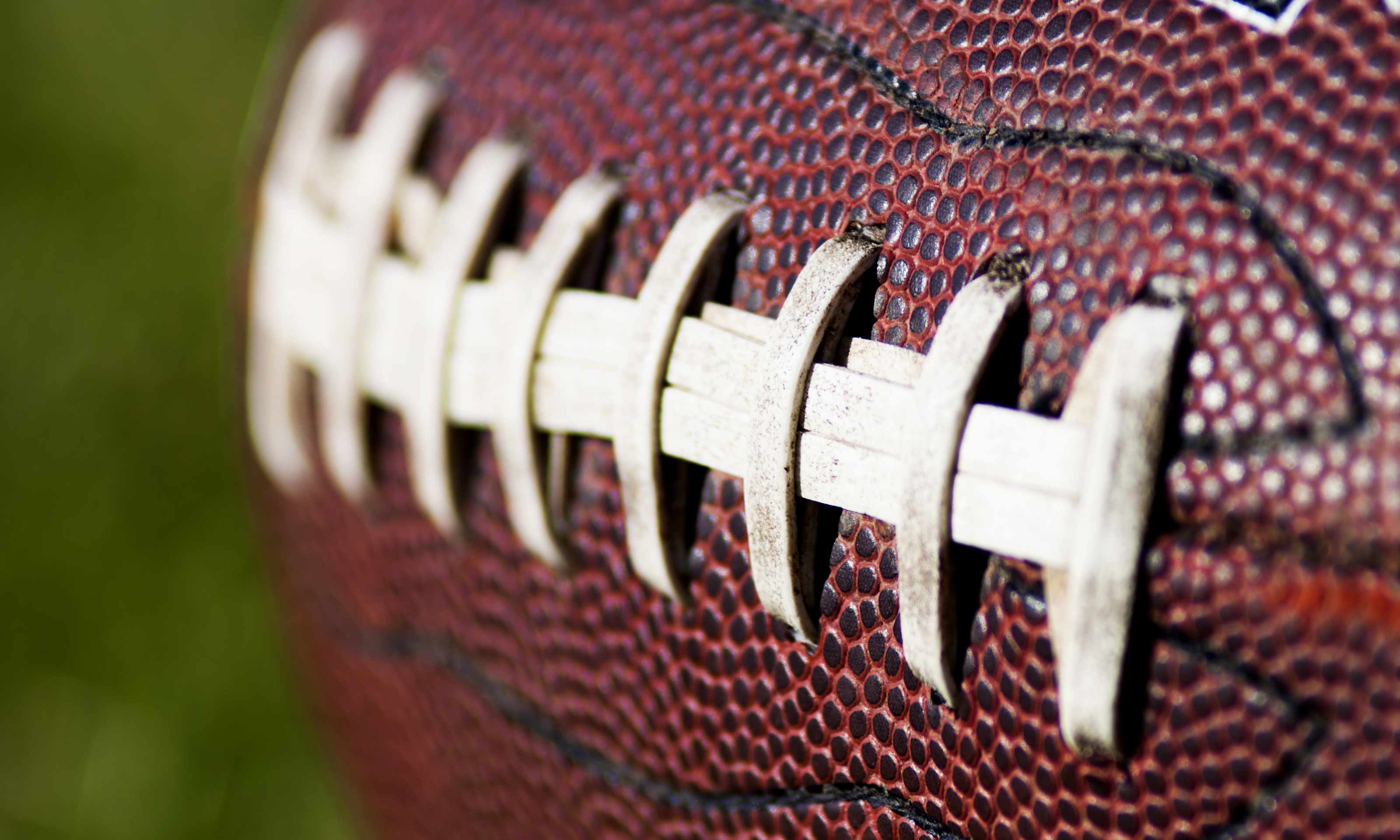 close up of football on green field