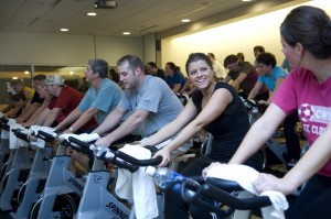 Male and females cycling in a fitness class