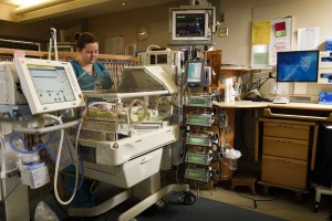 Nurse caring for a neonate in an incubator