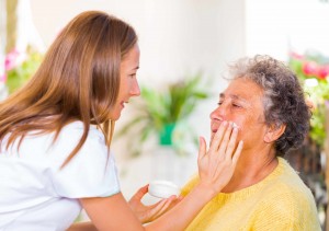 young nurse giving care to eldery person in hospital, hospice, palliative care