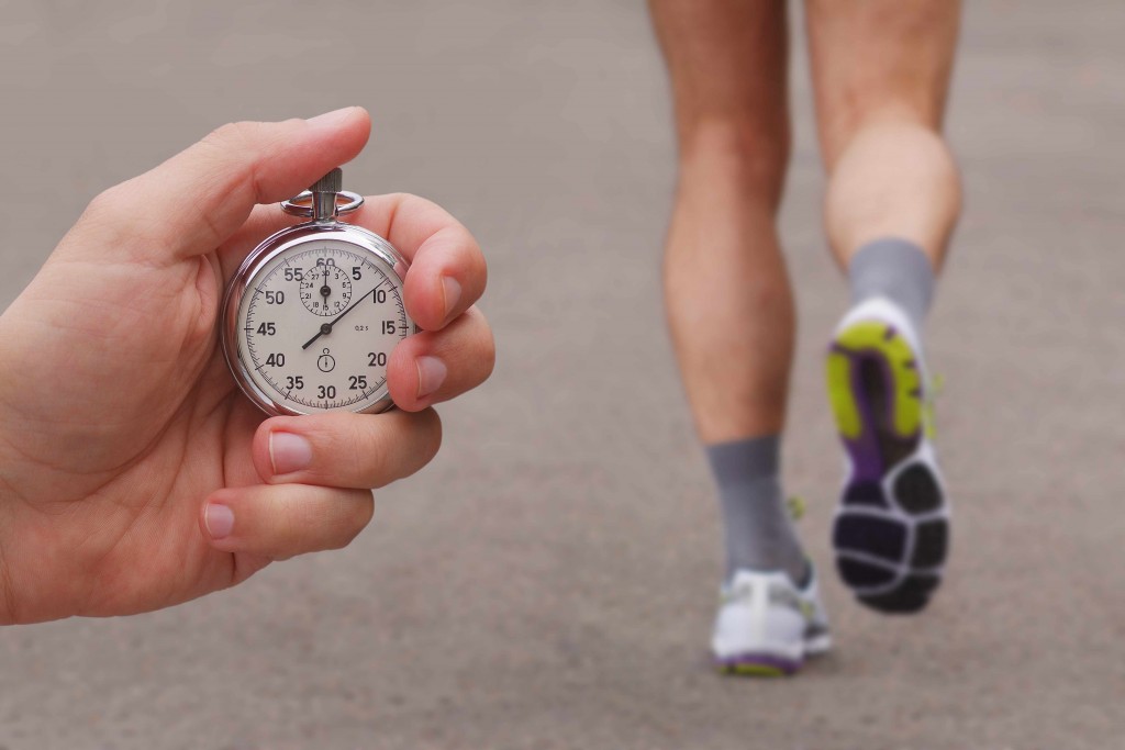 runner in a race with person holding a stopwatch
