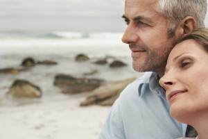 middle aged man and woman on beach, romantic