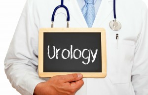 medical staff person holding chalkboard with the word urology