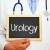 medical staff person holding chalkboard with the word urology