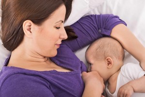 woman breast feeding, nursing baby