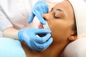woman having lip hair removed with hot wax, cosmotology