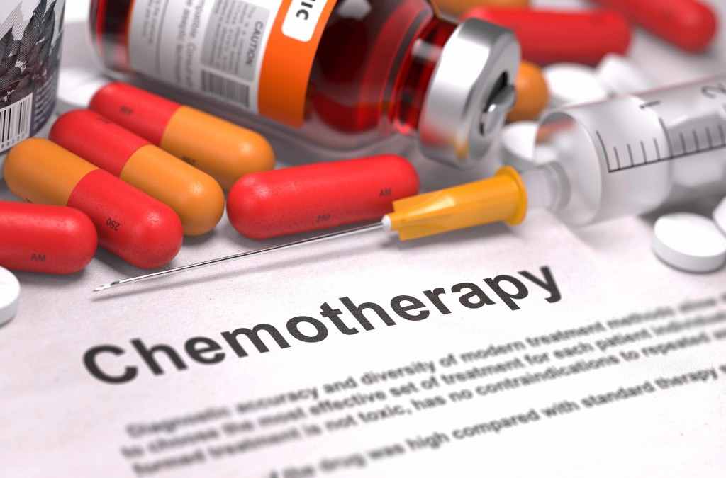 word chemotherapy on paper with pills and syringe, cancer