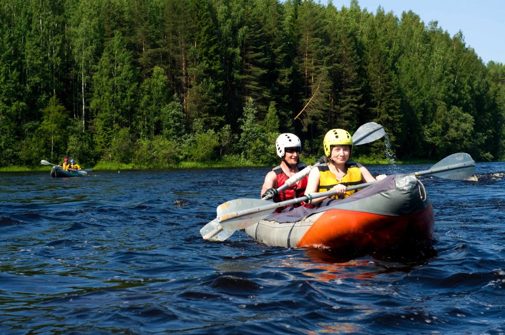 man and woman boating in a canoe on a lake, water safety