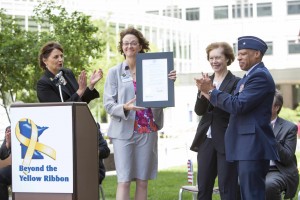 Stephanie Starr, M.D., receives the Yellow Ribbon plaque from (left to right) Annette Kuyper, Director of Military Outreach, Beyond the Yellow Ribbon; Tina Smith, Minnesota Lieutenant Governor; and Minnesota National Guard Air Force Brigadier General David Hamlar, M.D., D.D.S.