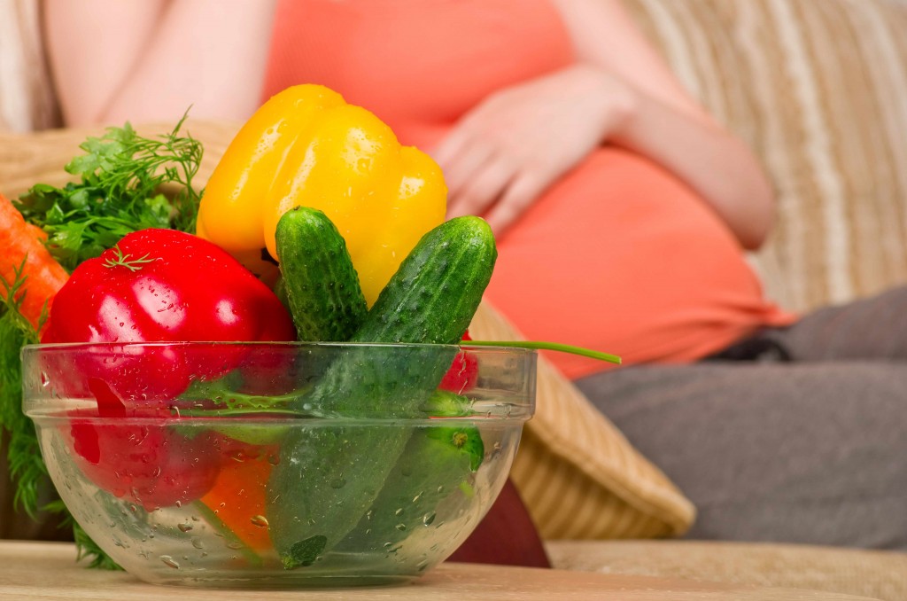 pregnant woman eating healthy vegetables