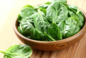 bowl of spinach lettuce leaves representing vitamin E