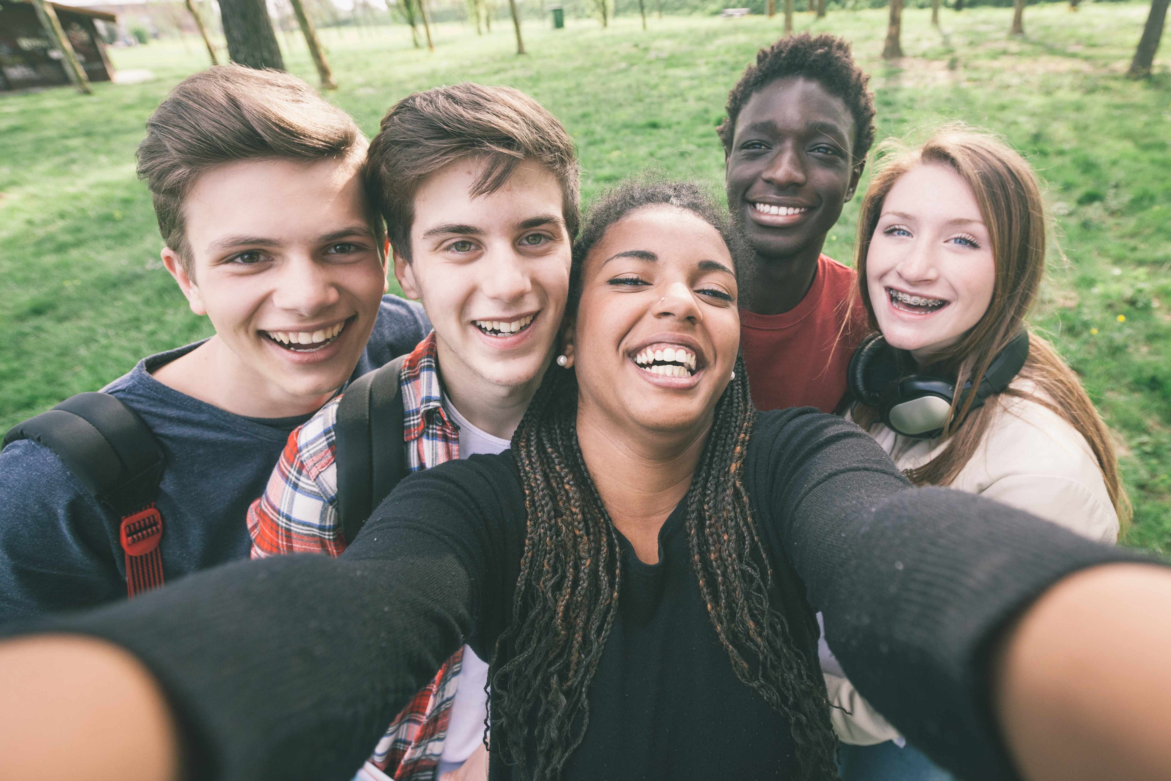 young people taking a selfie picture, laughing and smiling