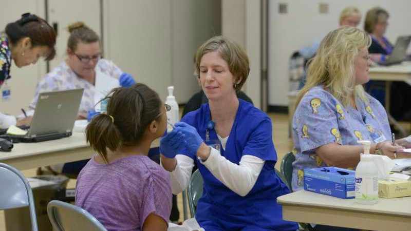 Girl getting flu mist vaccine