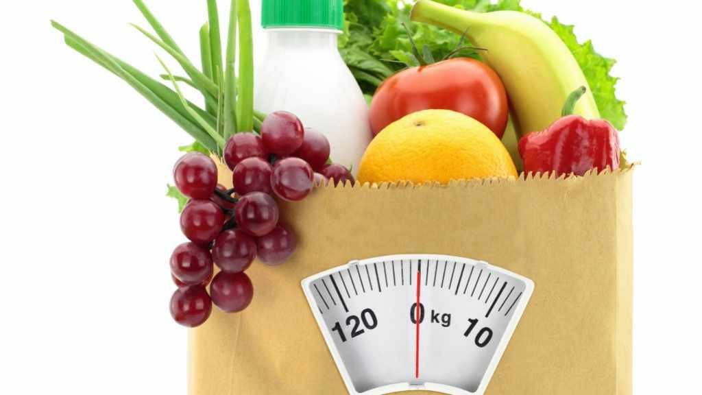 healthy food in grocery bag with scale