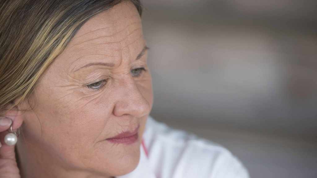 a middle-aged woman looking sad, worried, depressed