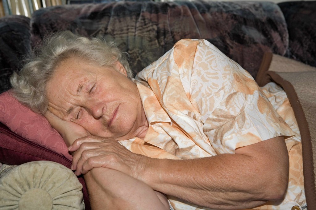 older woman sleeping on couch