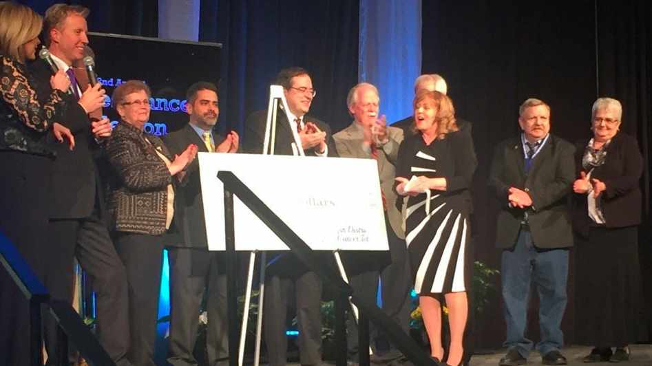 Dr. Robert Diasio, on stage with ceremonial check from the 2015 5th District Eagles Cancer Telethon.