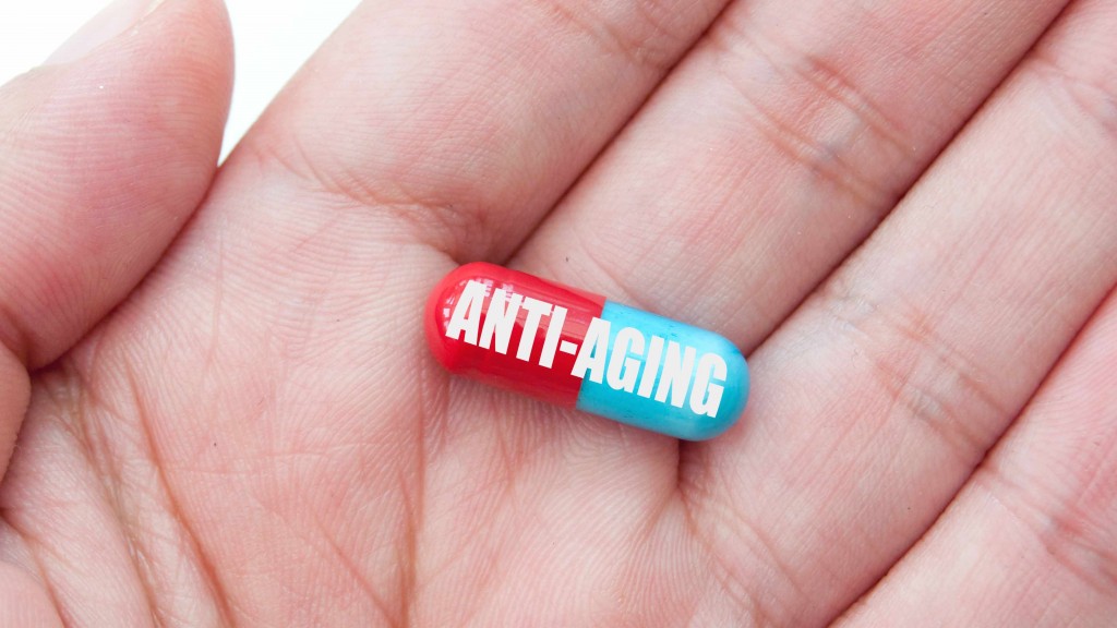 anti-aging pill held in a hand 