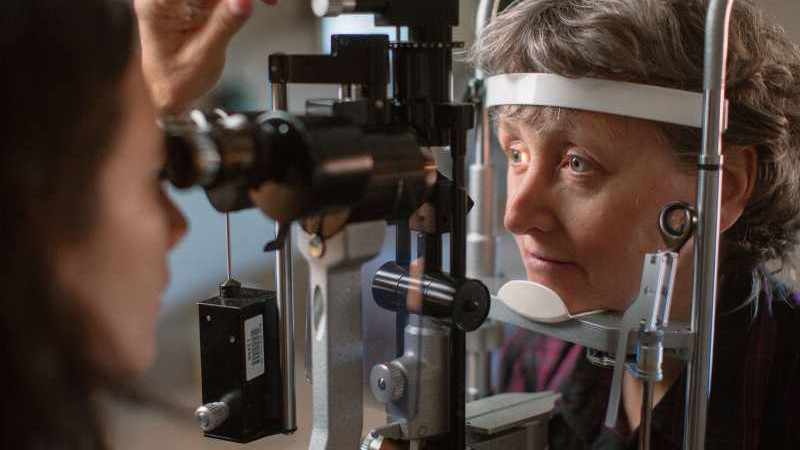 older woman having an eye exam, testing for glaucoma