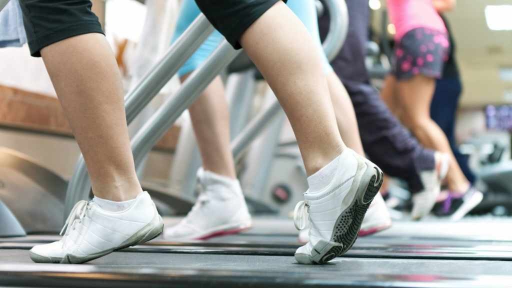 people exercising by walking, running on treadmills