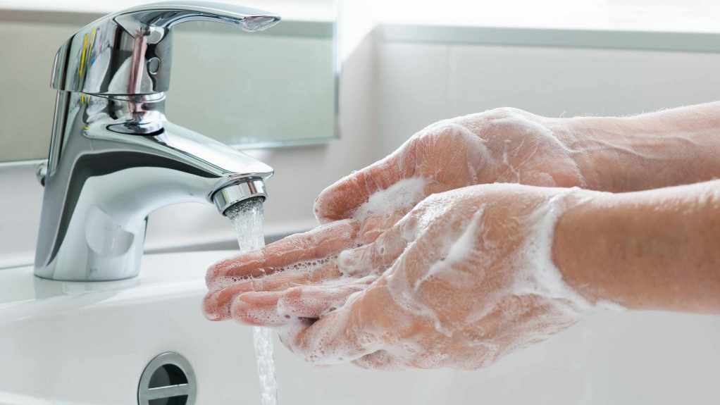hands being washed with soap in sink