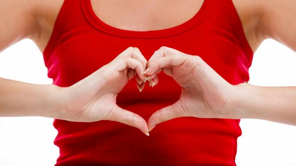 woman making heart health shape with her hands