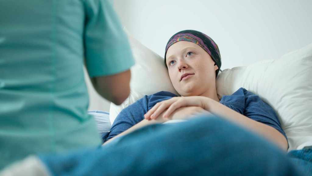 cancer patient with head scarf resting in bed