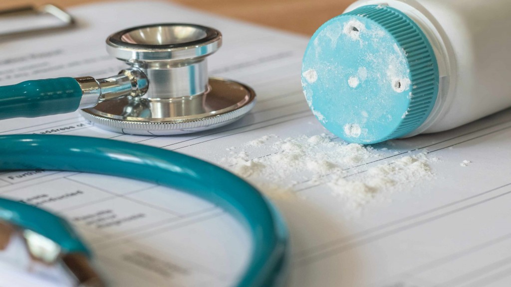 baby powder made of talc spilled onto medical records with stethoscope on the table