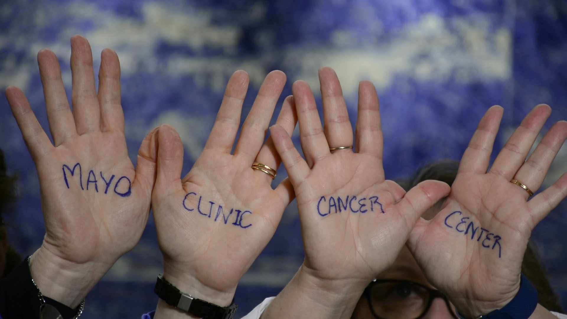 hands with writing that says Mayo Clinic Cancer Center