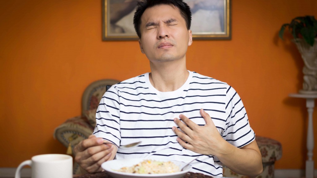 a man experiencing chest pain while eating food