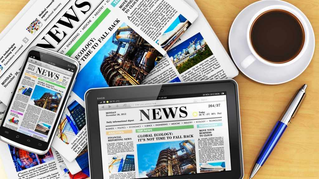 newspaper, phone and tablet displaying news