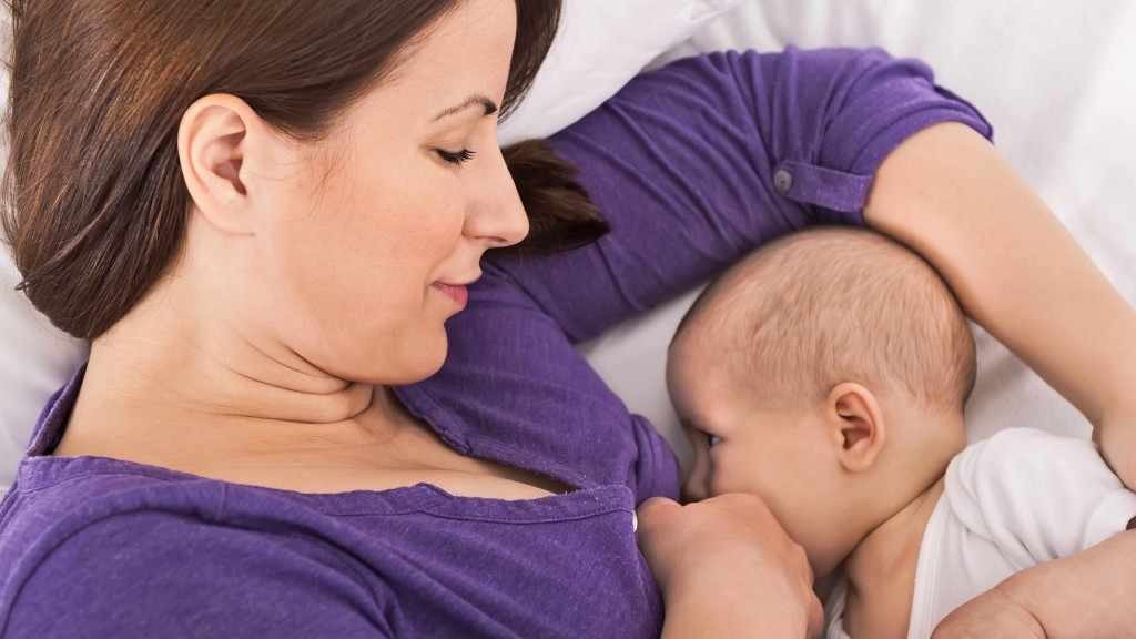 a woman breast-feeding a baby