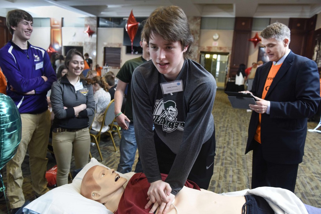 students doing CPR on the Gus mannequin