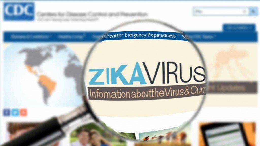 a computer monitor screen of the CDC website with a magnifying glass, illustrating the words "Zika virus"