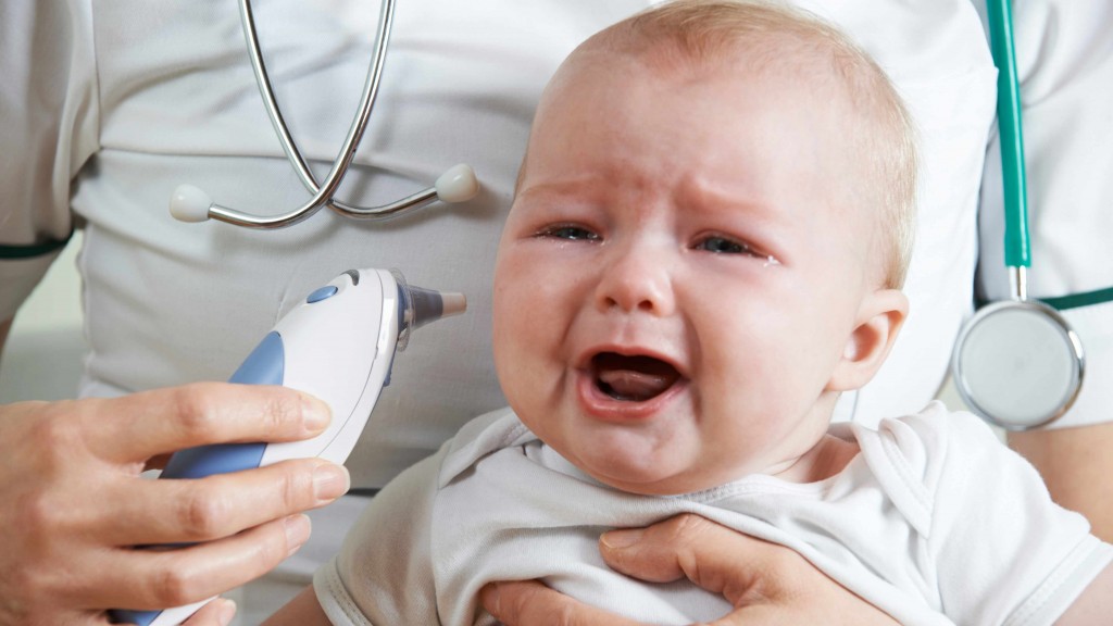 a crying baby sitting on nurses