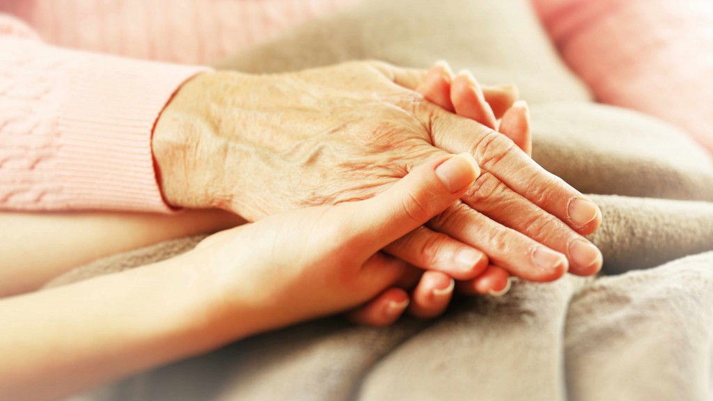 an older person's hand holding a child's hand