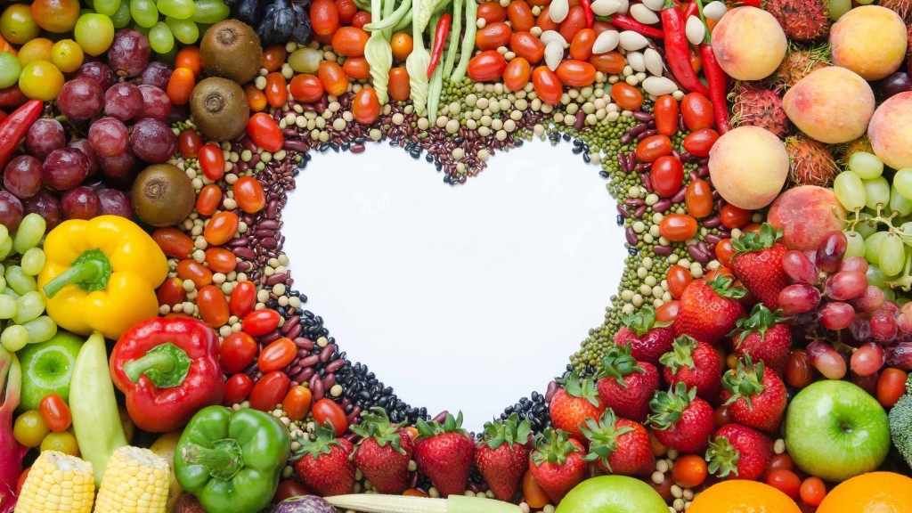 assorted fruits and vegetables formed into a heart